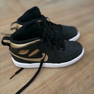 Boys Nike Jordan 1s black and gold